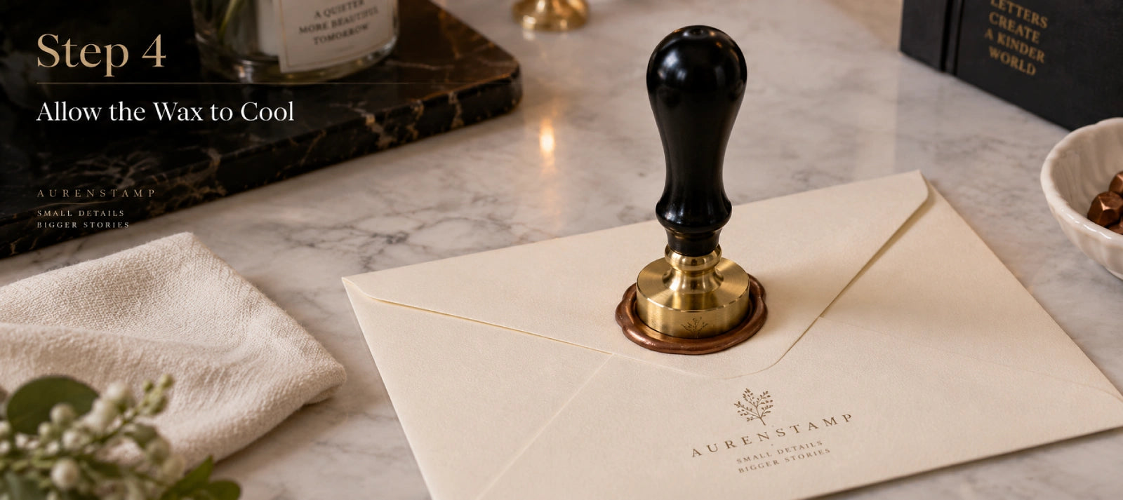 Wax seal stamp resting upright in warm wax on an envelope while the impression cools and sets.